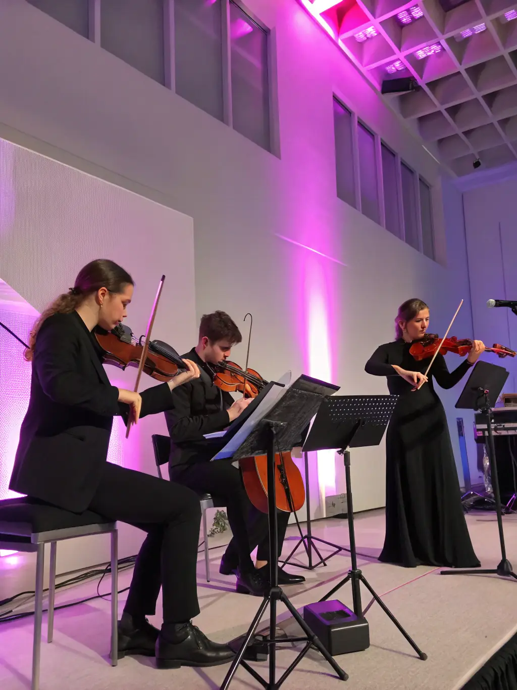 A photo of a string quartet performing at a local community center, emphasizing the agency's commitment to bringing music to diverse audiences.